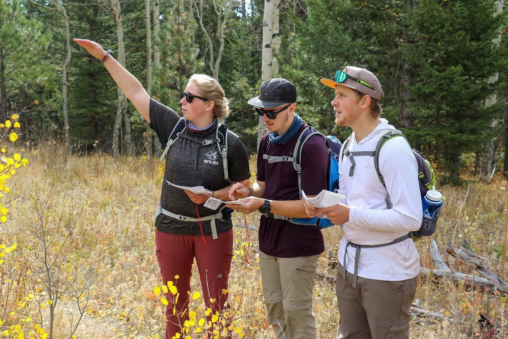 Students on a ridgeline studying the surrounding terrain